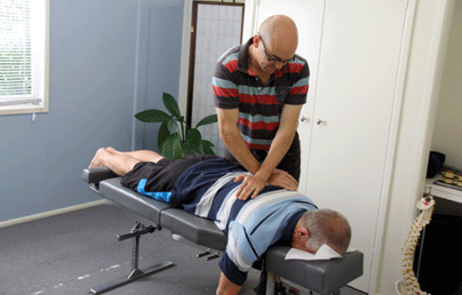 Our Warner Chiropractor Dr David Malone performing a chiropractic technique